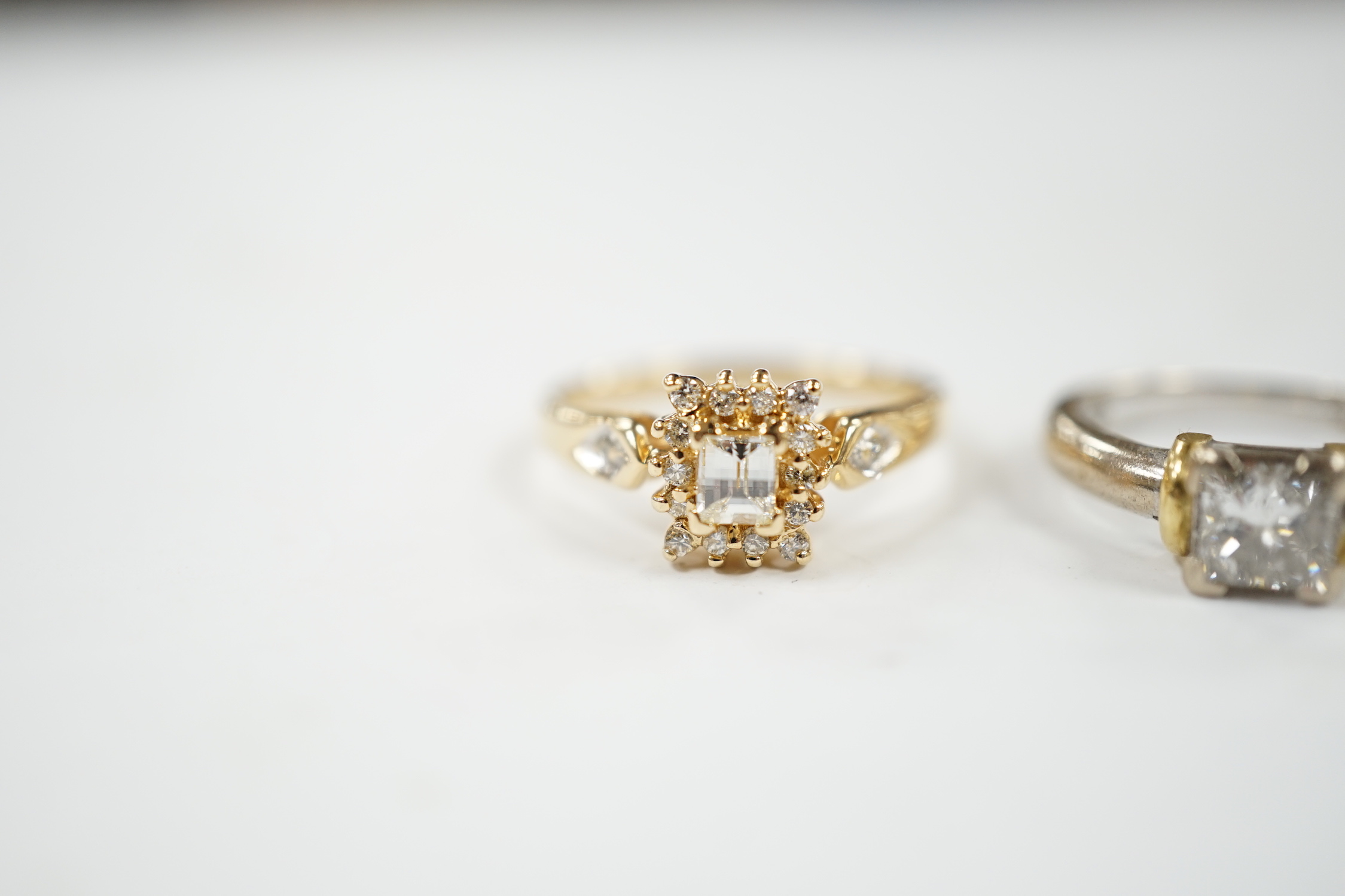 A modern two colour 18ct gold and solitaire princess cut diamond set ring, size K/L and one other modern 18ct gold and diamond set cluster ring, size N, gross weight 7.6 grams.